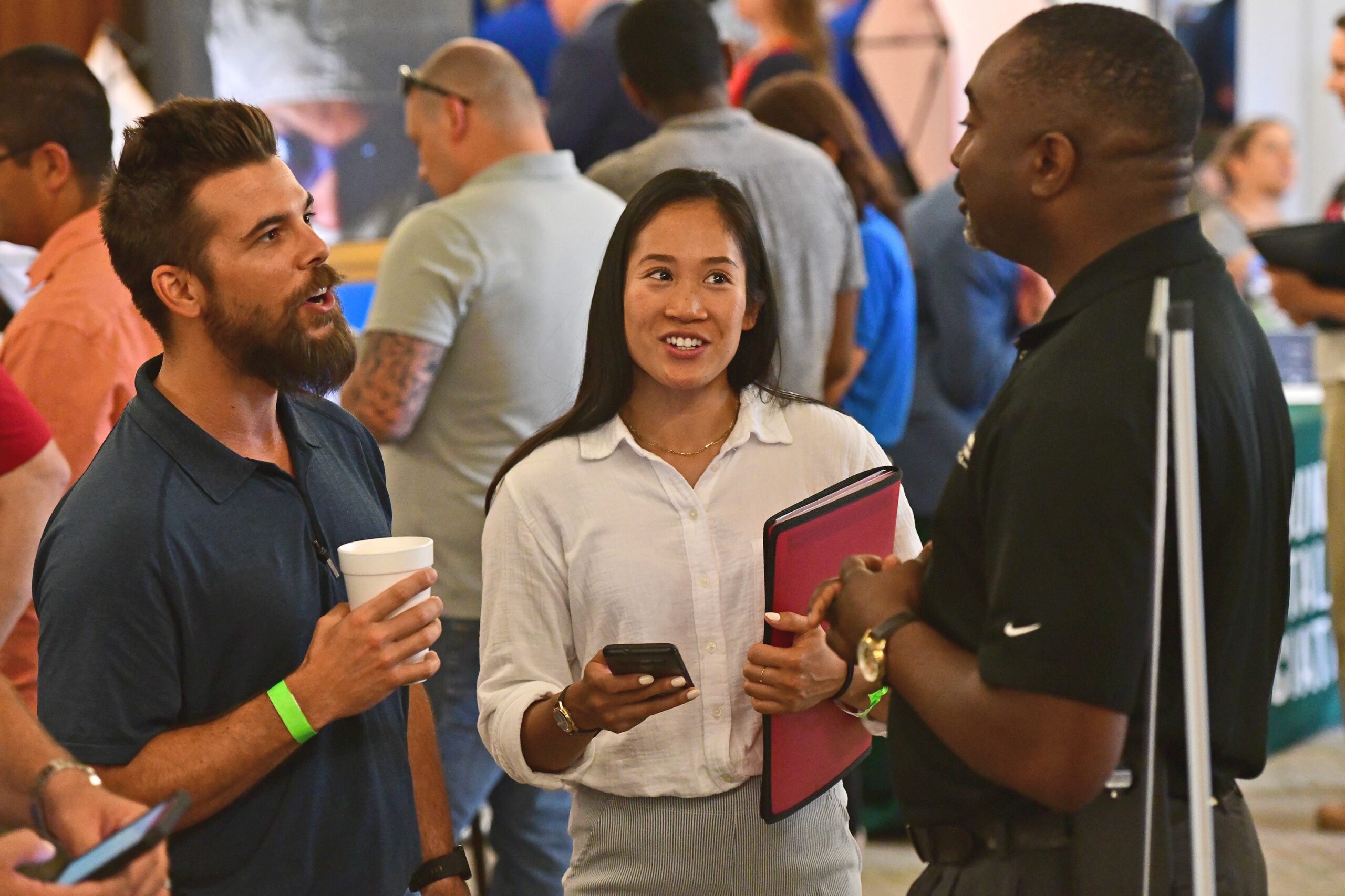 Man and woman smiling and looking to the right in conversation with a potential employer