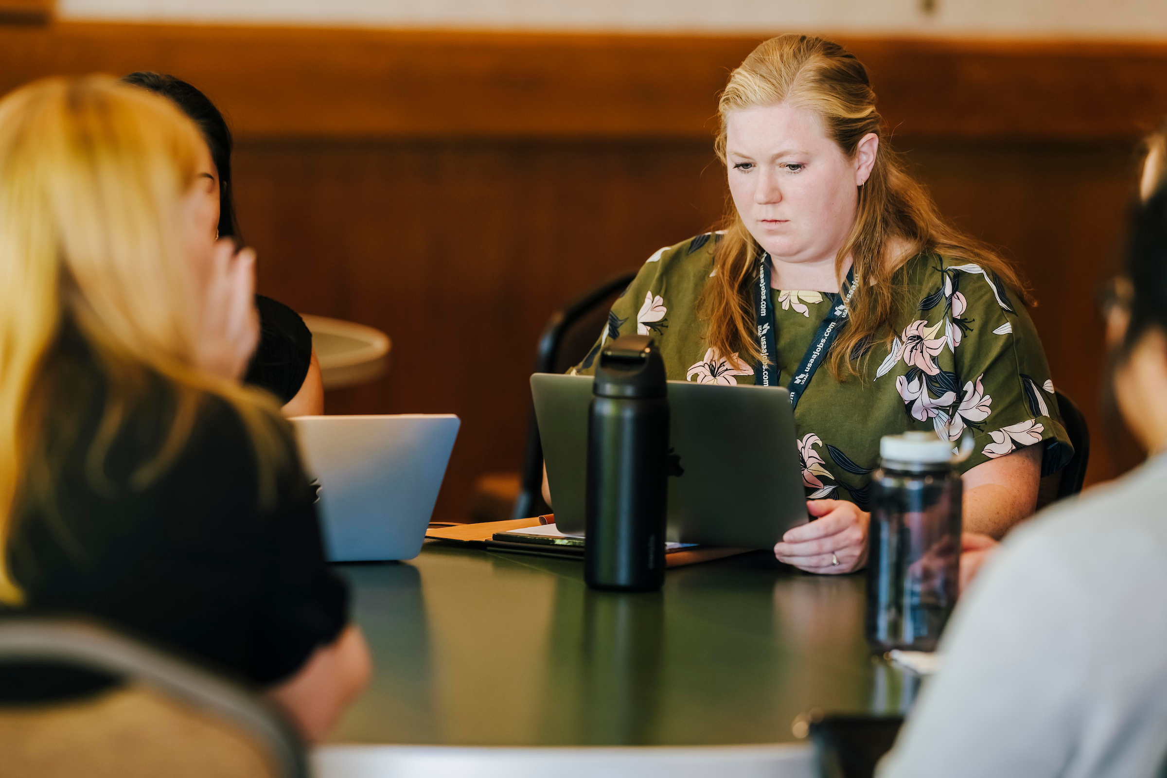 Women sit around a table during Hiring Our Heroes event