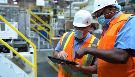 Two workers talk inside a Nestlé USA factory