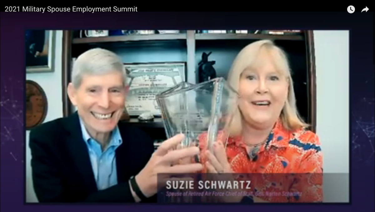 Suzie Schwartz holding the Bonnie Amos Impact Award for Lifetime Achievement