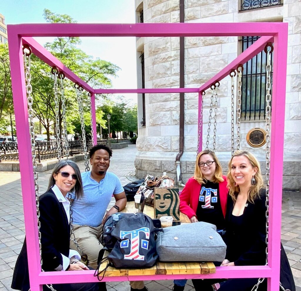 Coworkers enjoy coffee outside