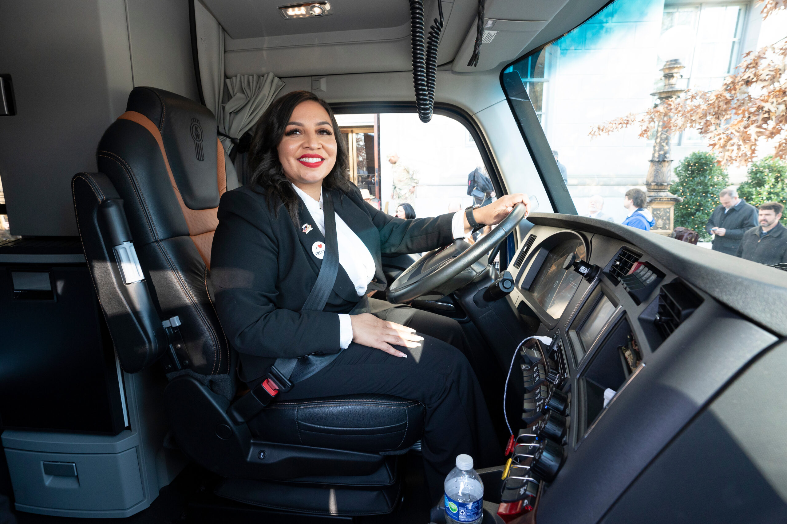 Army veteran Ashley Leiva at the wheel of brand-new fully loaded Kenworth T680 truck